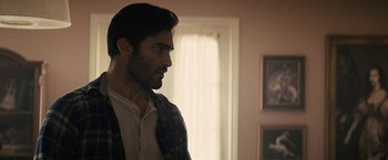 Movie still from “The Domestics” (2018), directed by Mike P. Nelson – A person in a room near a window; Close Up shot, Over the shoulder angle