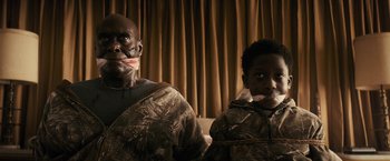 Movie still from “The Domestics” (2018), directed by Mike P. Nelson – A man and a boy in costume posing for a picture; Medium shot, Low angle