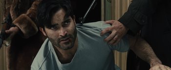 Movie still from “The Domestics” (2018), directed by Mike P. Nelson – A man holding his arm around another mans shoulder; Close Up shot, Over the shoulder angle