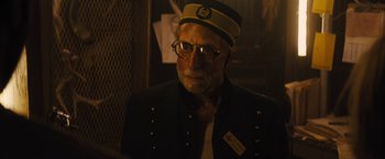 Movie still from “The Domestics” (2018), directed by Mike P. Nelson – An older man wearing a hat and glasses; Close Up shot, Low angle