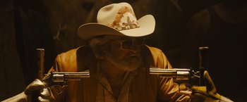Movie still from “The Domestics” (2018), directed by Mike P. Nelson – An older man wearing a cowboy hat and sunglasses; Close Up shot, Over the shoulder angle