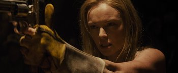 Movie still from “The Domestics” (2018), directed by Mike P. Nelson – A woman holding a banana in her hand; Close Up shot, Over the shoulder angle