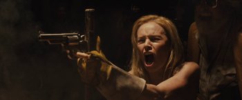 Movie still from “The Domestics” (2018), directed by Mike P. Nelson – A woman is holding a gun in her hand; Close Up shot, Low angle