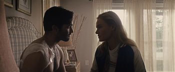 Movie still from “The Domestics” (2018), directed by Mike P. Nelson – A man and a woman face to face in a living room; Medium shot, Over the shoulder angle