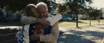 Movie still from “The Domestics” (2018), directed by Mike P. Nelson – An older man hugging a younger woman outside; Medium shot, Over the shoulder angle