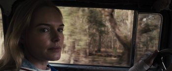 Movie still from “The Domestics” (2018), directed by Mike P. Nelson – A person looking out a car window; Close Up shot, Over the shoulder angle