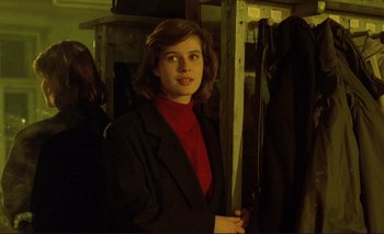 Movie still from “The Double Life of Véronique” (1991), directed by Krzysztof Kieslowski – A woman in a red shirt and black jacket; Medium shot, Over the shoulder angle