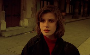 Movie still from “The Double Life of Véronique” (1991), directed by Krzysztof Kieslowski – A young woman in a red shirt and a black jacket; Close Up shot, High angle
