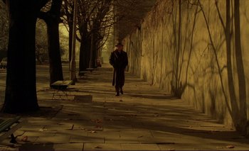 Movie still from “The Double Life of Véronique” (1991), directed by Krzysztof Kieslowski – An old man walking down the street at night; Wide shot, Low angle