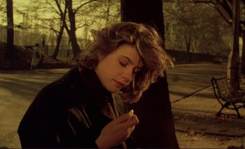 Movie still from “The Double Life of Véronique” (1991), directed by Krzysztof Kieslowski – A young woman is looking down at a piece of food; Close Up shot, High angle