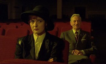 Movie still from “The Double Life of Véronique” (1991), directed by Krzysztof Kieslowski – A man and a woman sitting in a movie theater; Medium shot, High angle
