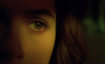 Movie still from “The Double Life of Véronique” (1991), directed by Krzysztof Kieslowski – A person's eye with a dark background; Extreme Close Up shot, Overhead angle