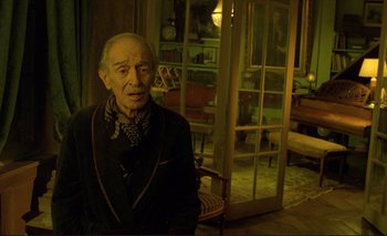 Movie still from “The Double Life of Véronique” (1991), directed by Krzysztof Kieslowski – An old man is sitting in front of a window; Medium shot, High angle