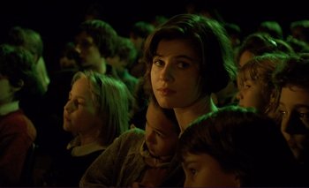 A group of people sitting in a dark room at night