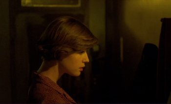Movie still from “The Double Life of Véronique” (1991), directed by Krzysztof Kieslowski – A woman with short brown hair looking to the side; Close Up shot, Over the shoulder angle