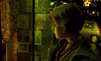 Movie still from “The Double Life of Véronique” (1991), directed by Krzysztof Kieslowski – A young girl looking out a window at a christmas tree; Close Up shot, Over the shoulder angle