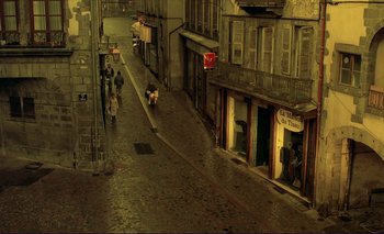 Movie still from “The Double Life of Véronique” (1991), directed by Krzysztof Kieslowski – An empty street in a city at night; Extreme Wide shot, High angle