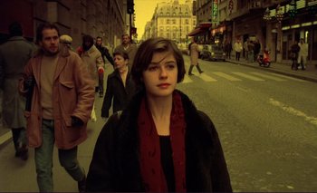 Movie still from “The Double Life of Véronique” (1991), directed by Krzysztof Kieslowski – A woman is walking down the street in the city; Medium shot, High angle
