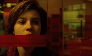 Movie still from “The Double Life of Véronique” (1991), directed by Krzysztof Kieslowski – A young woman looking out of a train window; Close Up shot, Low angle
