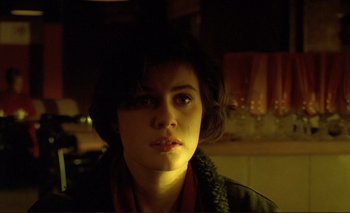 Movie still from “The Double Life of Véronique” (1991), directed by Krzysztof Kieslowski – A young woman is looking into the camera; Close Up shot, Over the shoulder angle
