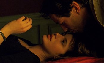 Movie still from “The Double Life of Véronique” (1991), directed by Krzysztof Kieslowski – A man and a woman laying on a bed together; Close Up shot, Overhead angle