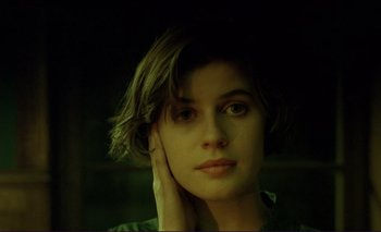 Movie still from “The Double Life of Véronique” (1991), directed by Krzysztof Kieslowski – A person with short brown hair; Close Up shot, High angle