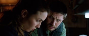 Movie still from “The Drop” (2014), directed by Michaël R. Roskam – A man and a woman looking at one another; Close Up shot, Over the shoulder angle