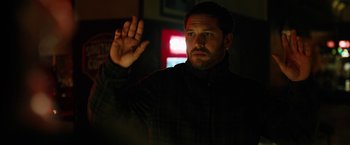 Movie still from “The Drop” (2014), directed by Michaël R. Roskam – A man holding his hand up in the dark; Close Up shot, Low angle