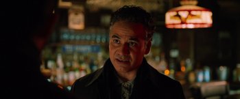 Movie still from “The Drop” (2014), directed by Michaël R. Roskam – A person wearing a jacket; Close Up shot, Over the shoulder angle