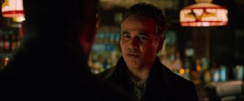 Movie still from “The Drop” (2014), directed by Michaël R. Roskam – A person talking to another person; Close Up shot, Over the shoulder angle