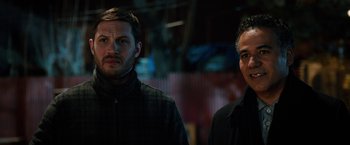 Movie still from “The Drop” (2014), directed by Michaël R. Roskam – Two men standing next to each other in the dark; Close Up shot, Over the shoulder angle