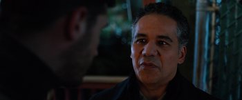 Movie still from “The Drop” (2014), directed by Michaël R. Roskam – A person talking to another person; Close Up shot, Over the shoulder angle