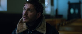 Movie still from “The Drop” (2014), directed by Michaël R. Roskam – A person wearing a jacket; Close Up shot, Over the shoulder angle