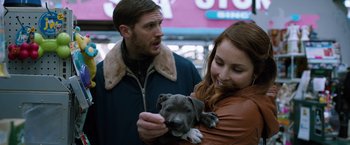 Movie still from “The Drop” (2014), directed by Michaël R. Roskam – A man and a woman holding a puppy; Close Up shot, Over the shoulder angle