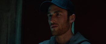 Movie still from “The Drop” (2014), directed by Michaël R. Roskam – A person wearing a hat; Close Up shot, Low angle