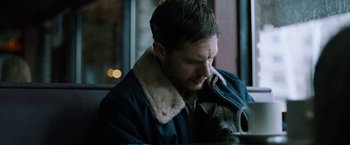 Movie still from “The Drop” (2014), directed by Michaël R. Roskam – A person wearing a jacket; Close Up shot, High angle