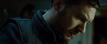 Movie still from “The Drop” (2014), directed by Michaël R. Roskam – A man with a beard; Close Up shot, Low angle