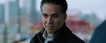 Movie still from “The Drop” (2014), directed by Michaël R. Roskam – A person wearing a jacket; Close Up shot, Over the shoulder angle