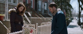 Movie still from “The Drop” (2014), directed by Michaël R. Roskam – A man and a woman standing next to each other; Medium shot, Over the shoulder angle