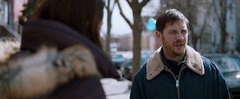 Movie still from “The Drop” (2014), directed by Michaël R. Roskam – A man and a woman standing next to each other on the sidewalk; Close Up shot, Over the shoulder angle