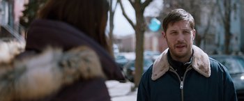 Movie still from “The Drop” (2014), directed by Michaël R. Roskam – A man and a woman standing next to each other on the sidewalk; Close Up shot, Over the shoulder angle
