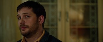 Movie still from “The Drop” (2014), directed by Michaël R. Roskam – A person wearing a jacket; Close Up shot, Over the shoulder angle