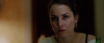 Movie still from “The Drop” (2014), directed by Michaël R. Roskam – A person looking at the camera; Close Up shot, Over the shoulder angle