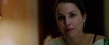 Movie still from “The Drop” (2014), directed by Michaël R. Roskam – A woman's face in a white sweater; Close Up shot, Over the shoulder angle