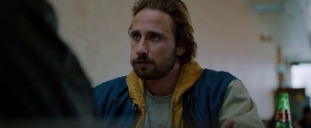 Movie still from “The Drop” (2014), directed by Michaël R. Roskam – A person wearing a jacket; Close Up shot, Low angle