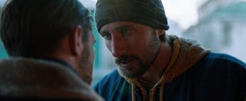 Movie still from “The Drop” (2014), directed by Michaël R. Roskam – A man with a beard talking to another man; Close Up shot, Over the shoulder angle
