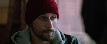 Movie still from “The Drop” (2014), directed by Michaël R. Roskam – A person wearing a red hat; Close Up shot, Over the shoulder angle