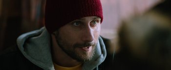 Movie still from “The Drop” (2014), directed by Michaël R. Roskam – A person wearing a red hat; Close Up shot, Over the shoulder angle