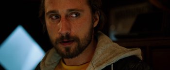 Movie still from “The Drop” (2014), directed by Michaël R. Roskam – A person with a beard; Close Up shot, Over the shoulder angle