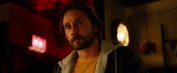 Movie still from “The Drop” (2014), directed by Michaël R. Roskam – A person with a beard; Close Up shot, Over the shoulder angle